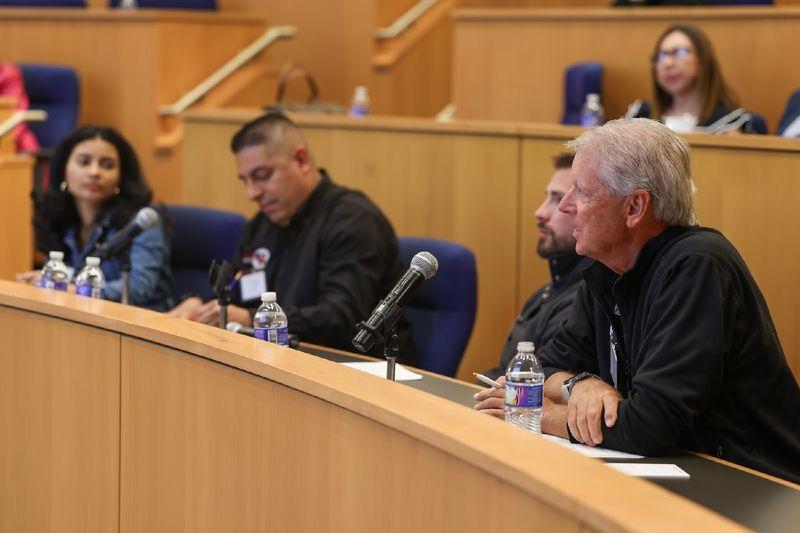 people sitting at table in auditorium